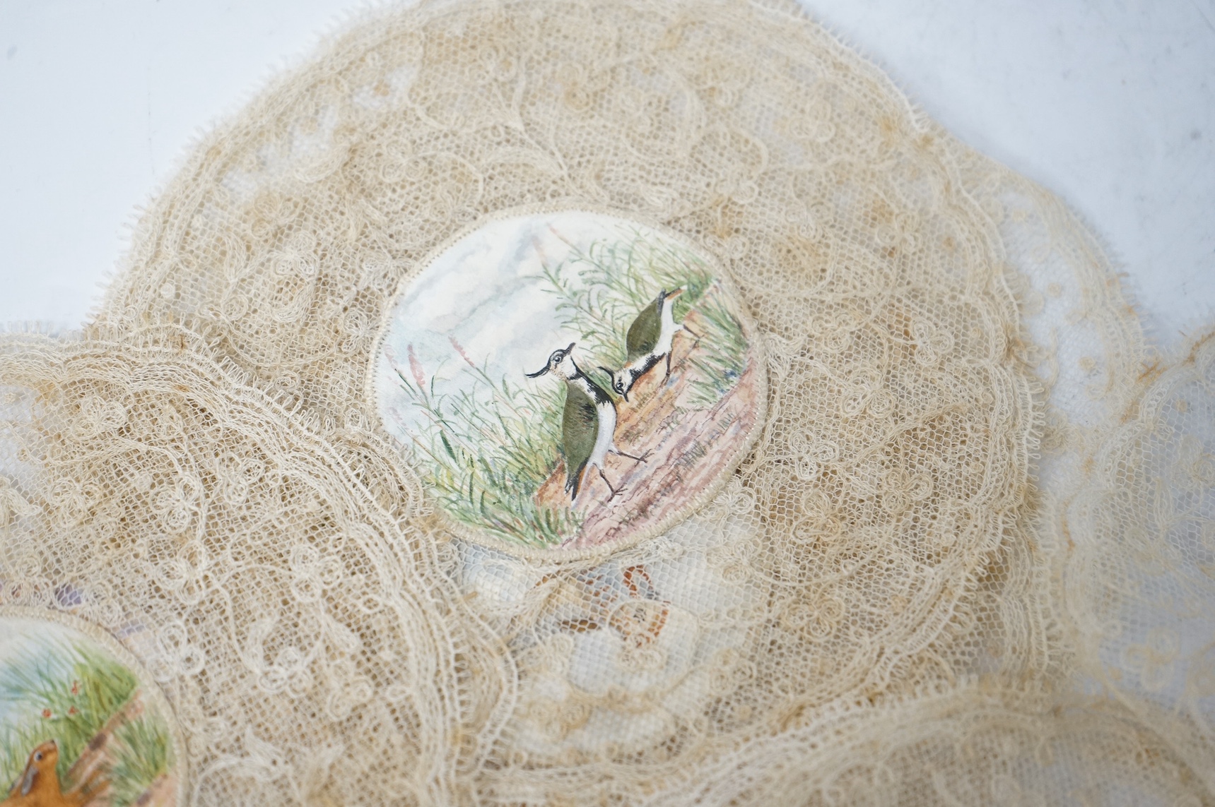 Eleven early 20th century circular mats, hand painted hunting related centres, edged with lace. 15cm diameter. Condition - some staining to lace